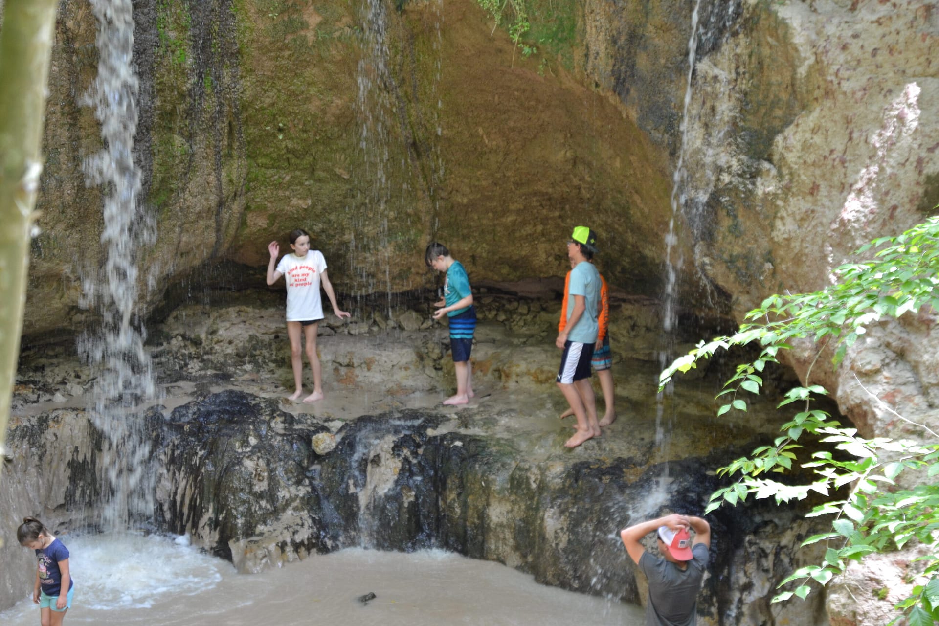 kids playing in Clark Creek waterfall