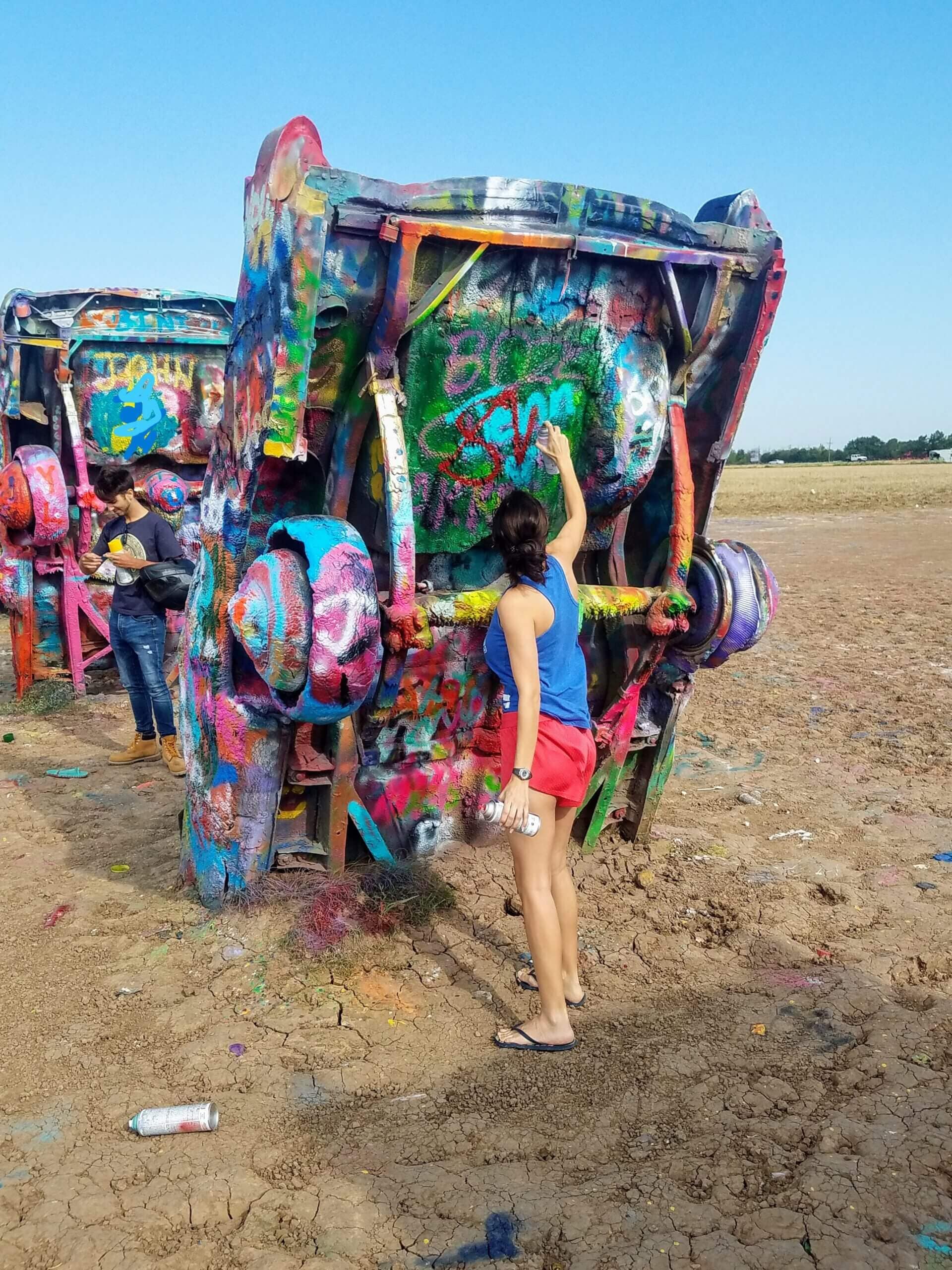 spray painting a car at Cadillac ranch