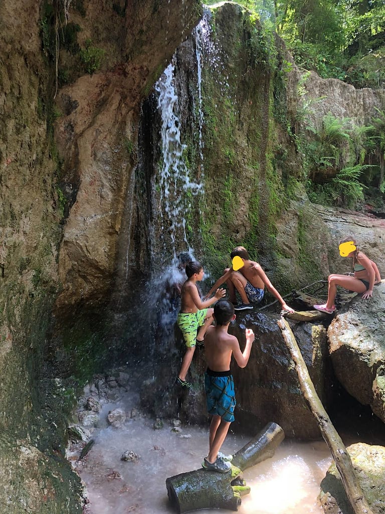 kids playing in clark creek waterfall